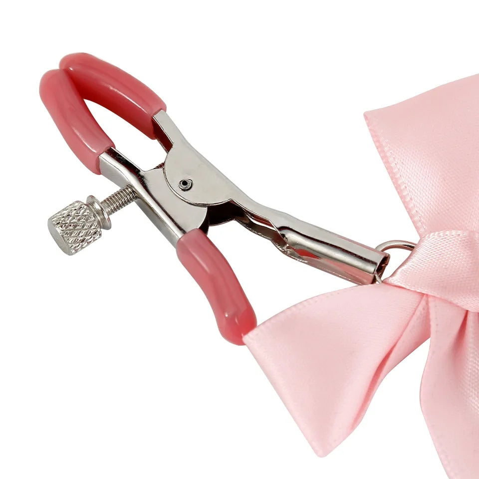 Pretty metal clamps covered in rubber. The clamp has a screw that allows you to adjust its clamping power to your specific tastes. The end of each clip is decorated with a small satin bow and a matching colored bell.
