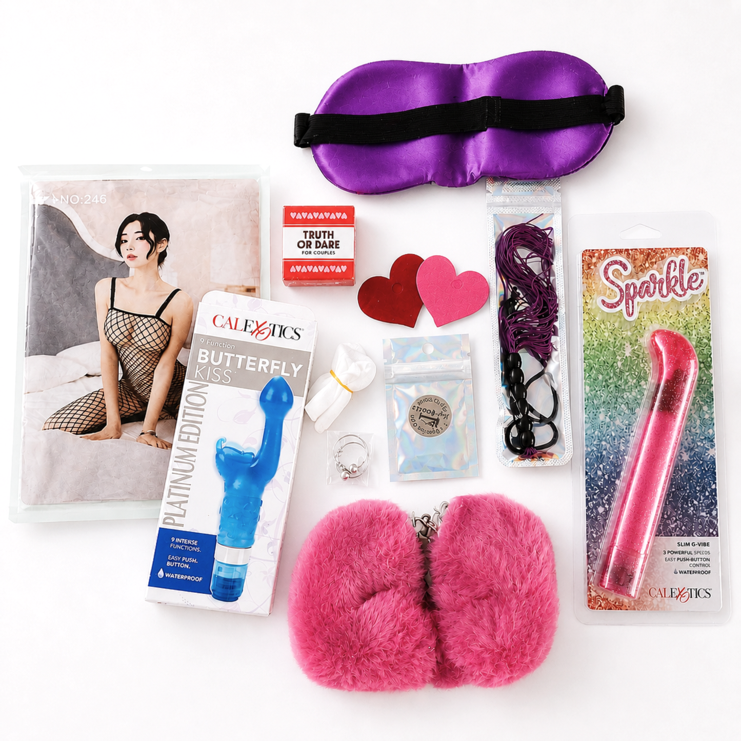 Sexy beginner couples gift set with fishnet bodysuit, vibrators, satin blindfold, fuzzy handcuffs, mini butt plug, couples game and sensual accessories flat lay on white background