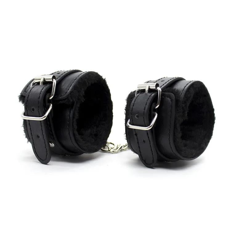 Faux leather furry handcuffs with plush lining and metal chain in black