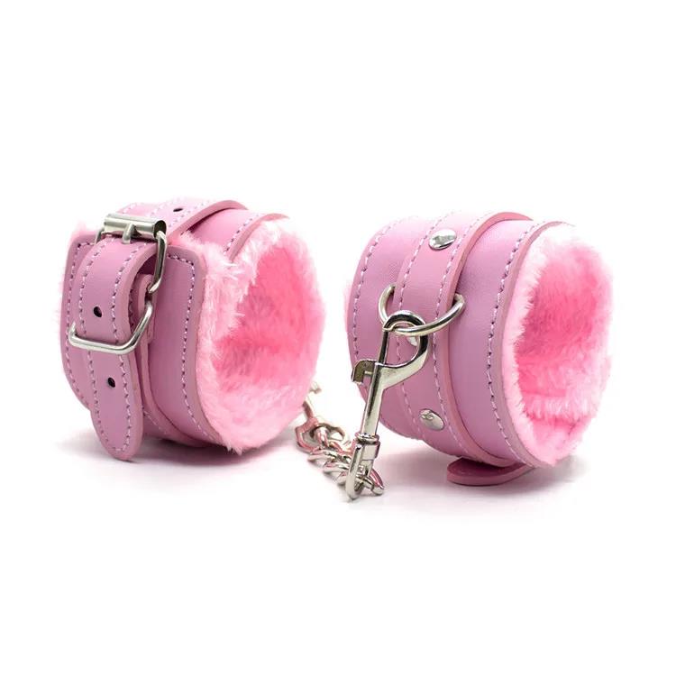 Faux leather furry handcuffs with plush lining and metal chain in pink
