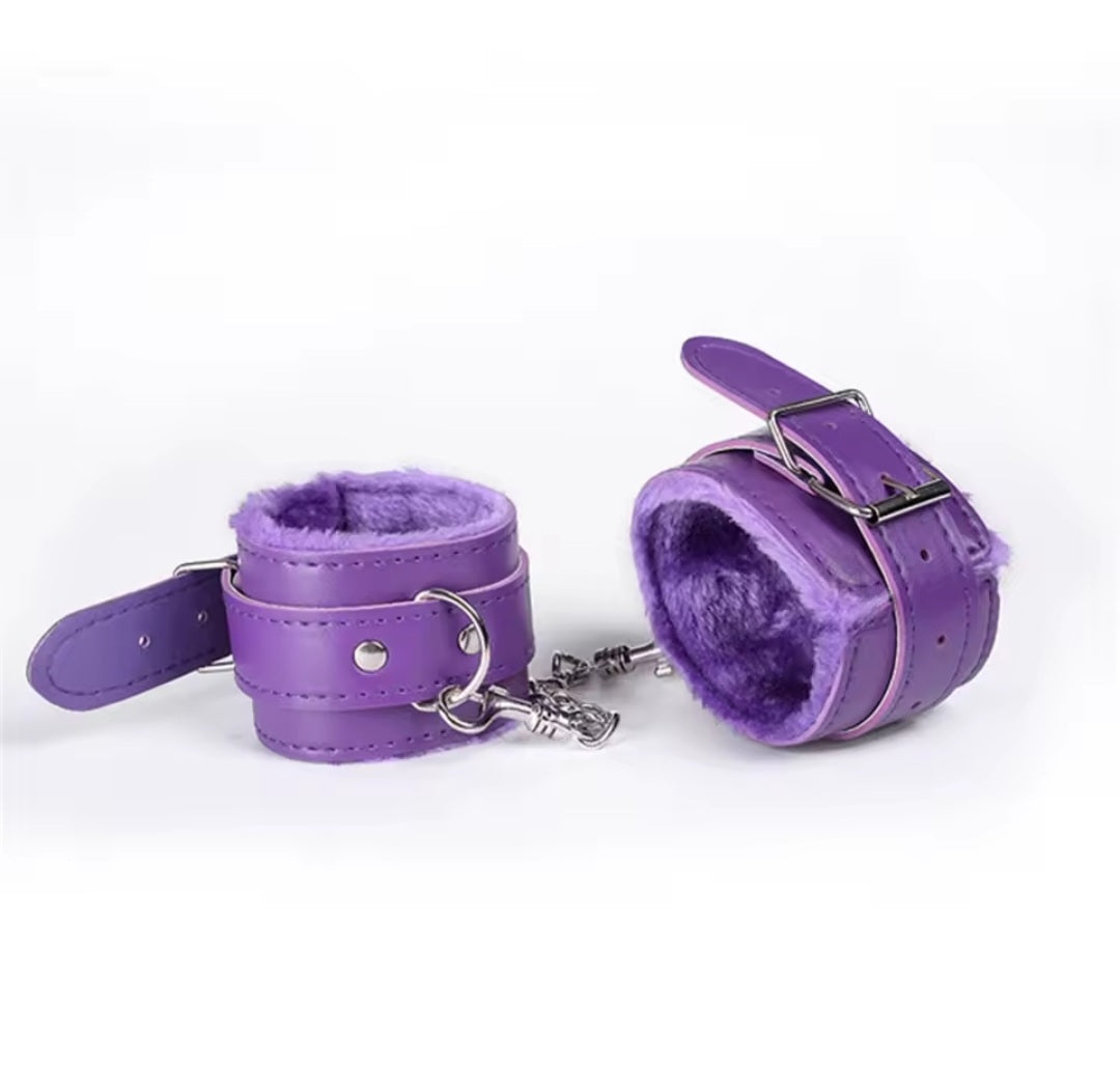 Faux leather furry handcuffs with plush lining and metal chain in purple