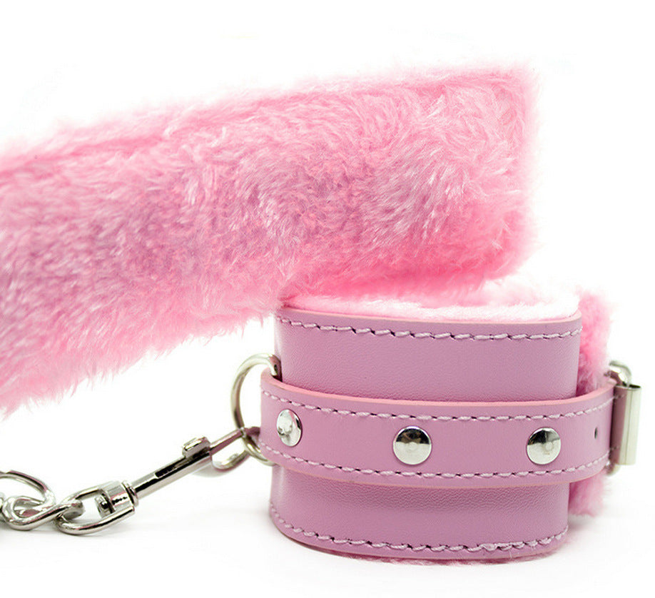 Faux leather furry handcuffs with plush lining and metal chain in pink
