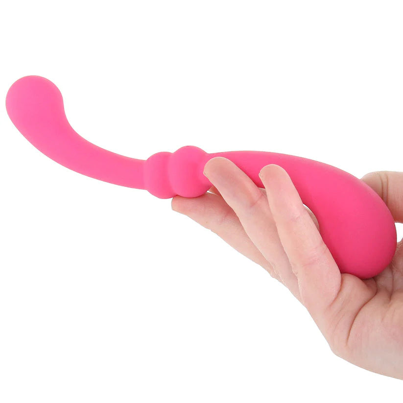 Pink pleasure kit with fishnet dress, remote control panties, wand massager, handcuffs, satin blindfold and romantic accessories
